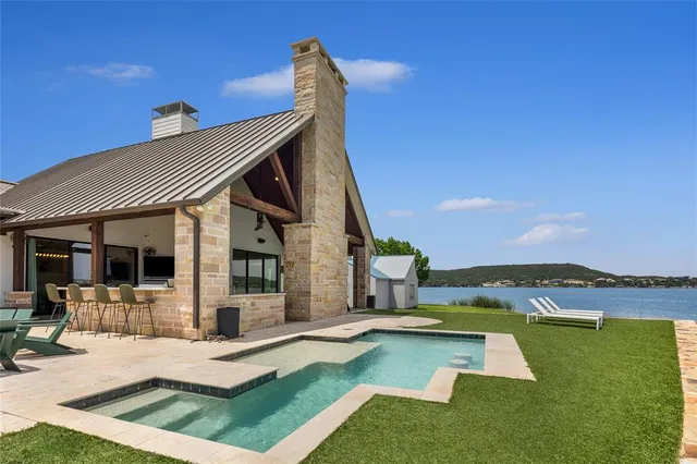 a view of a house with lounge chair and floor to ceiling window