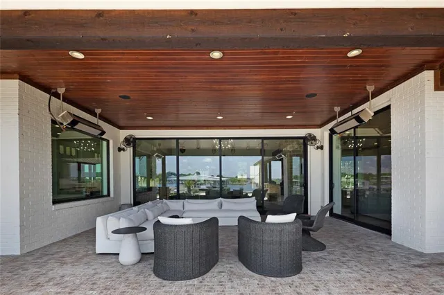 a living room with furniture and large windows