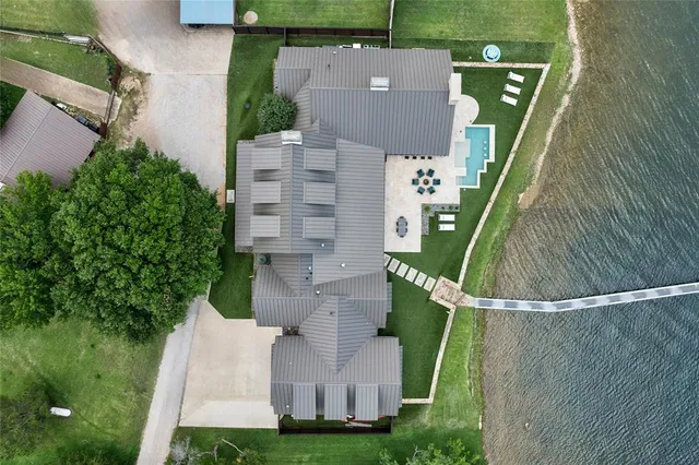 an aerial view of a house with a yard