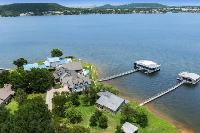 an aerial view of a house with a garden and lake view