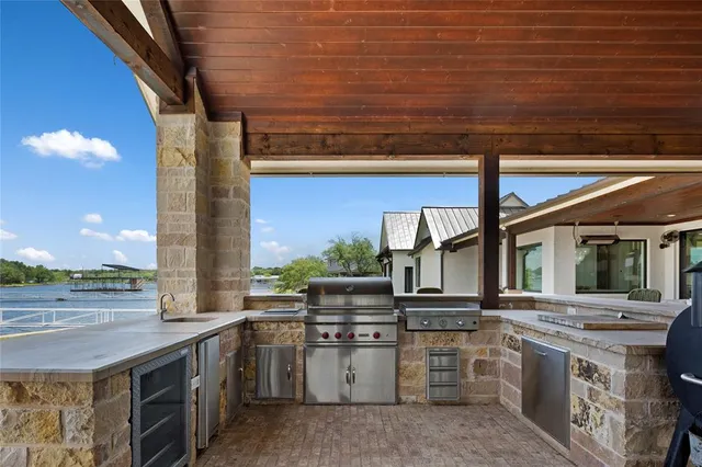 a kitchen with stainless steel appliances granite countertop a stove and a sink