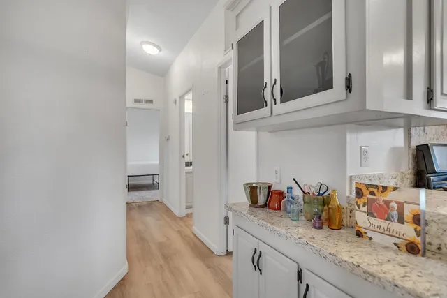 a kitchen with granite countertop a sink and cabinets