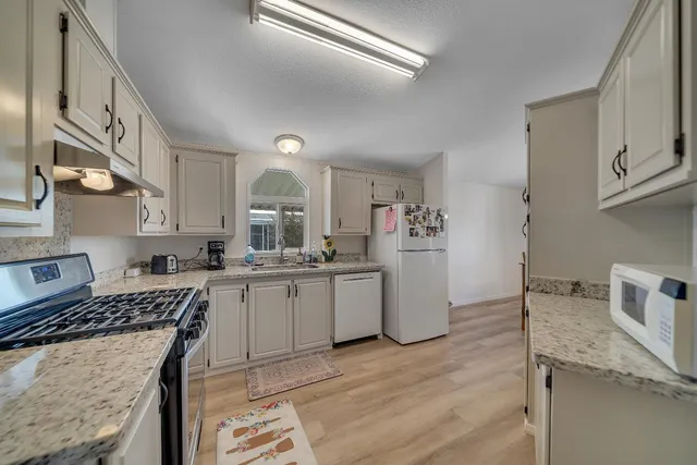 a kitchen with a sink stove and cabinets