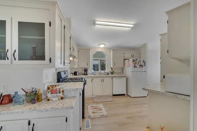 a kitchen with sink and cabinets