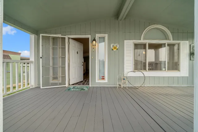 a view of outdoor space with wooden floor and windows