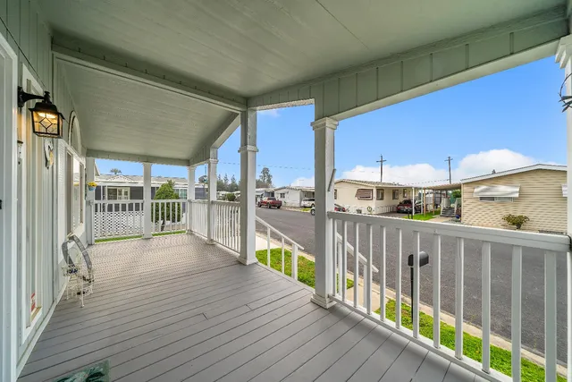 a view of a balcony with wooden floor