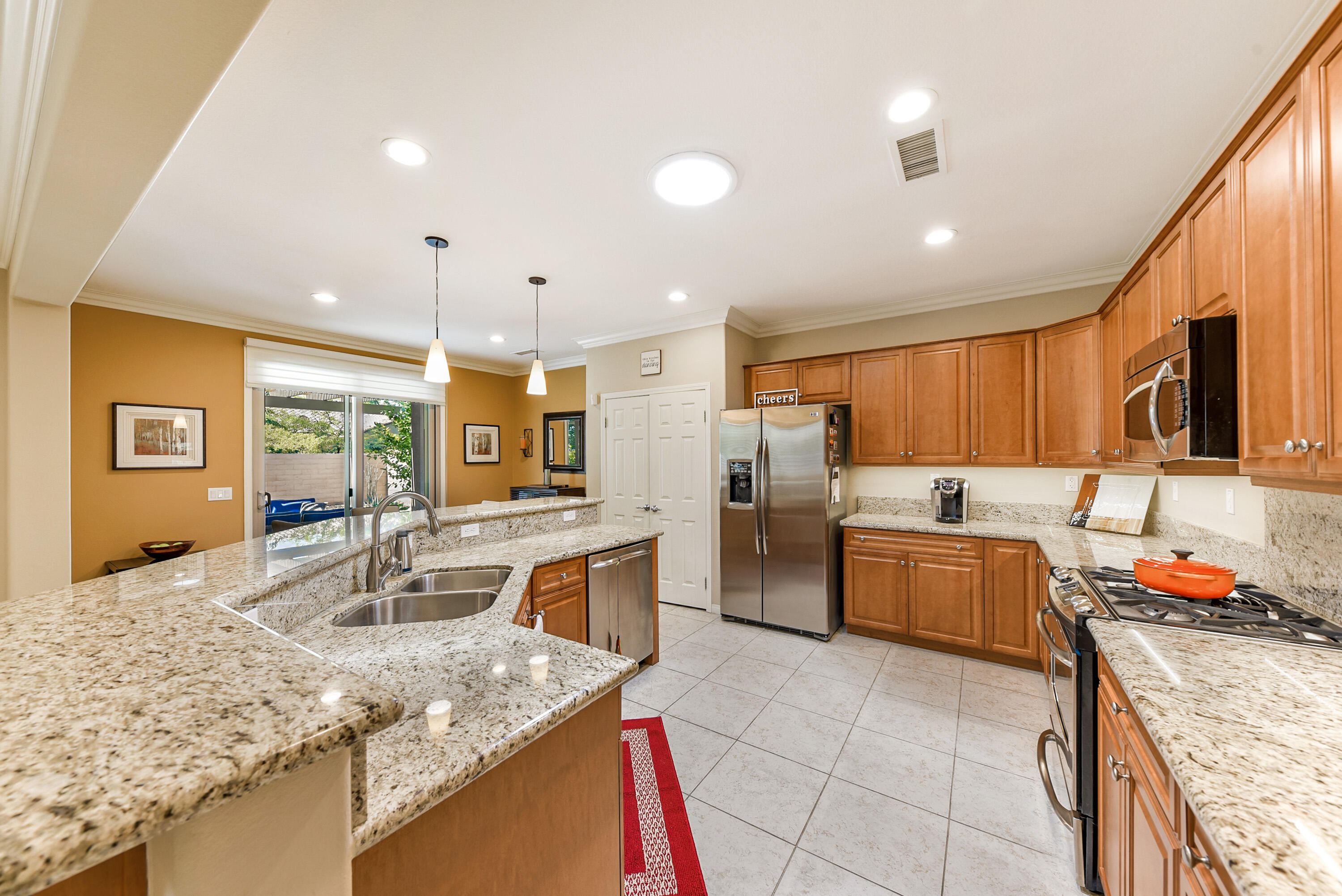 81190 Corte Del Olma Indio, CA 92203 - Photo 14 of 47 a kitchen with stainless steel appliances granite countertop a sink stove and refrigerator