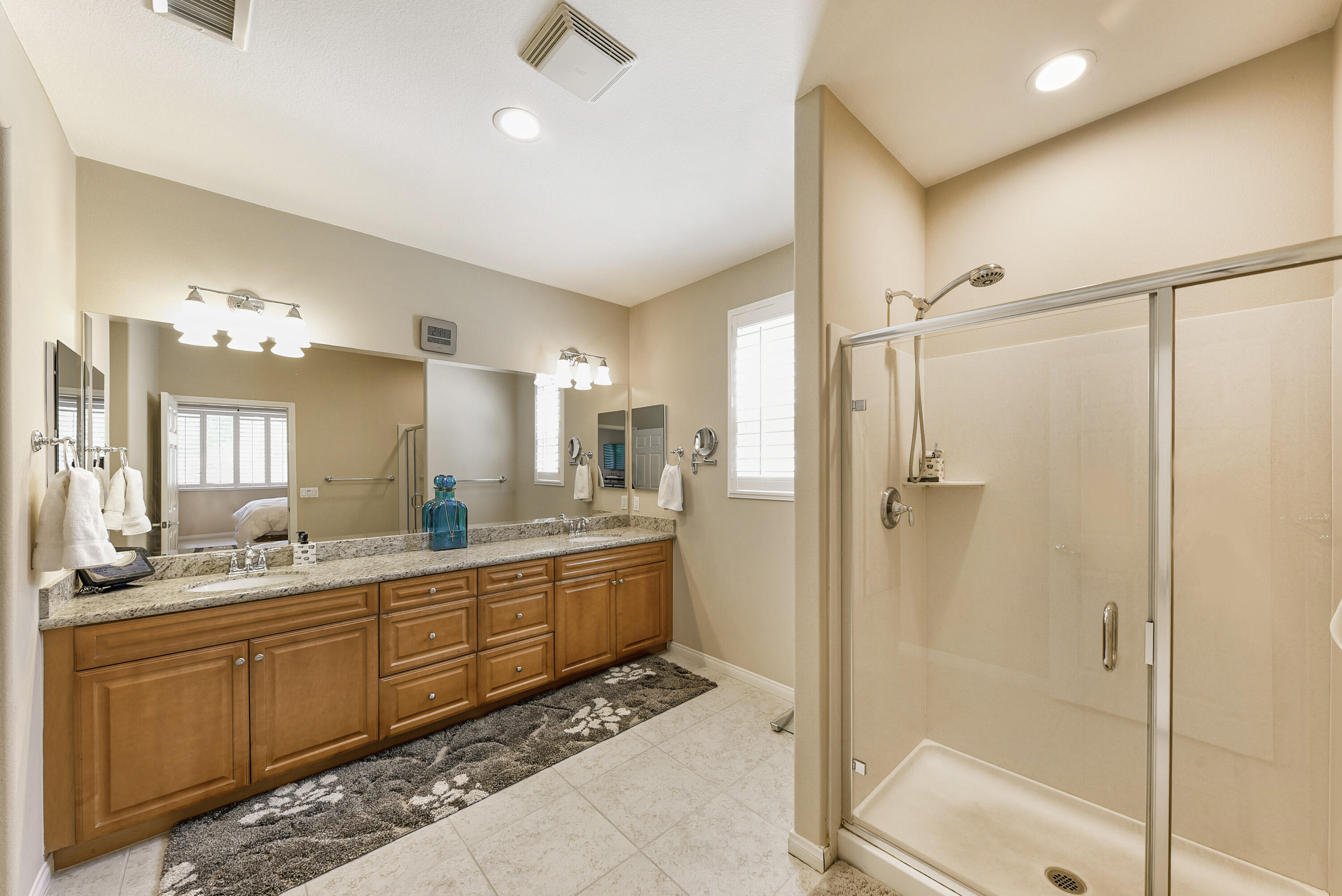 81190 Corte Del Olma Indio, CA 92203 - Photo 22 of 47 a bathroom with a double vanity sink mirror and shower