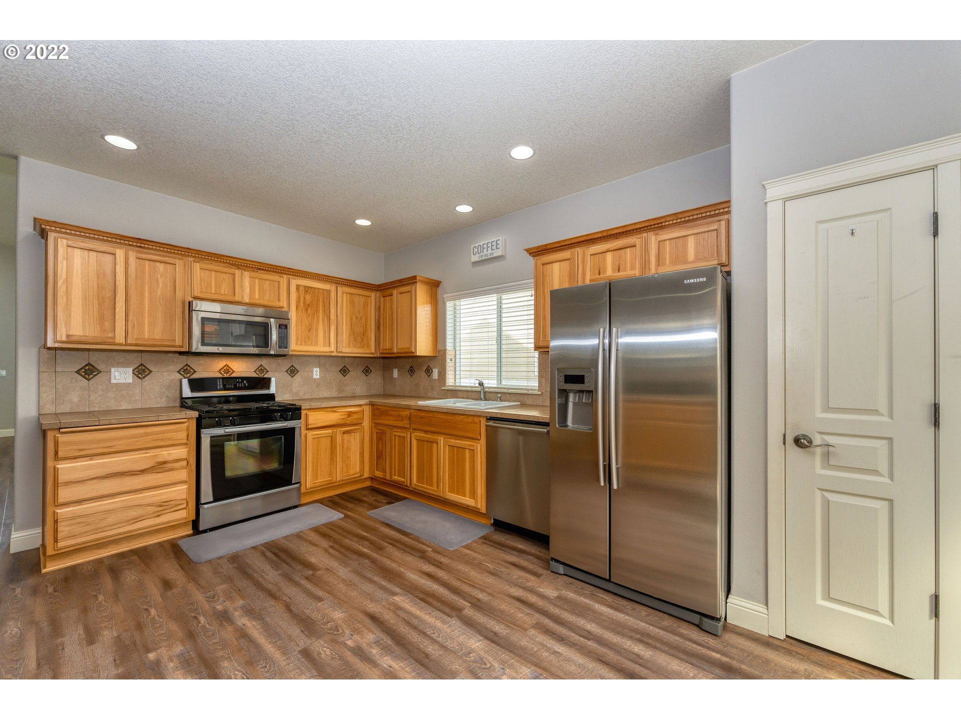 2785 North Fremont Street Cornelius, OR 97113 - Photo 8 of 32 a kitchen with granite countertop stainless steel appliances and wooden cabinets