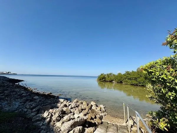 a kitchen that has a lot of cabinets and wooden floor