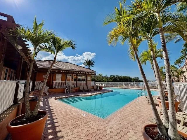 a kitchen with stainless steel appliances granite countertop a refrigerator a stove and a sink