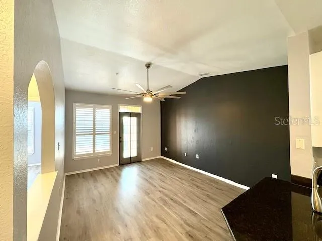 a view of a kitchen cabinets and a wooden floor