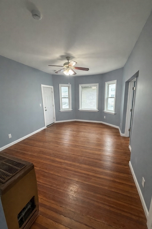 50 Haffards Street, Unit 1 Fall River, MA 02723 - Photo 5 of 8 a view of an empty room with wooden floor and a window