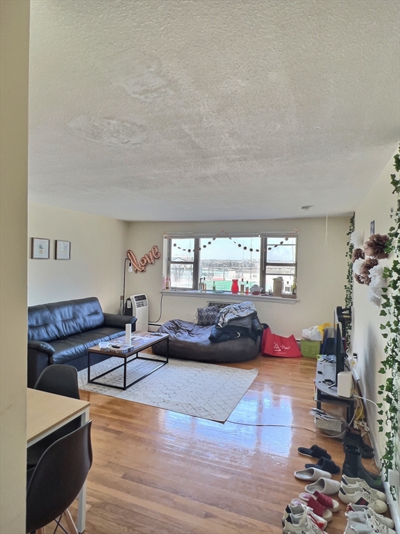 1039 Commonwealth Avenue, Unit 18 Boston, MA 02215 - Photo 2 of 6 a living room with furniture and a wooden floor