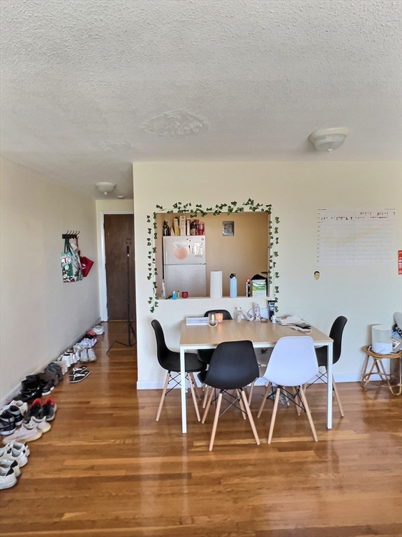 1039 Commonwealth Avenue, Unit 18 Boston, MA 02215 - Photo 3 of 6 a view of a dining room with furniture and wooden floor