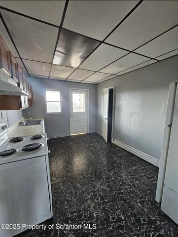 a view of empty room with window and fireplace