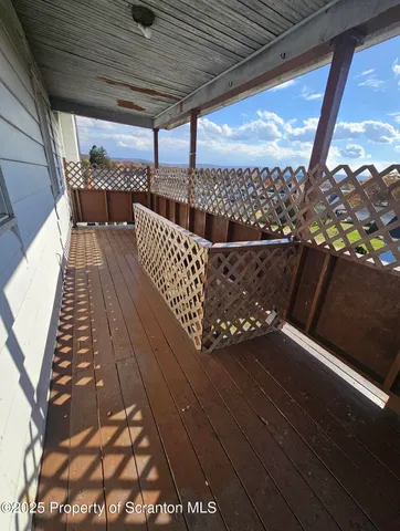a view of balcony with wooden floor