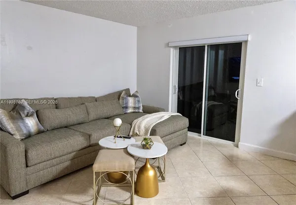 a living room with furniture and a rug