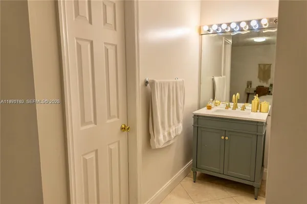 a bathroom with a sink a mirror and a shower