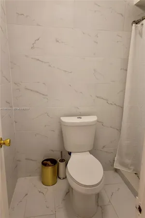 a white toilet sitting next to a white sink