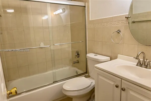a bathroom with a shower a toilet and sink