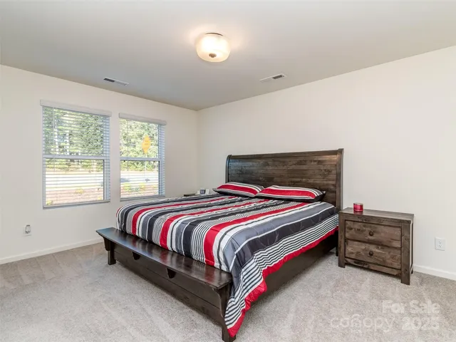 a bedroom with bed and a window