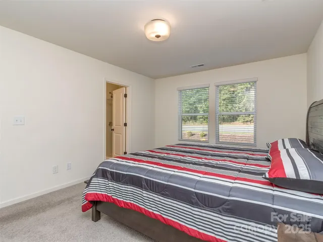 a bedroom with bed and a window