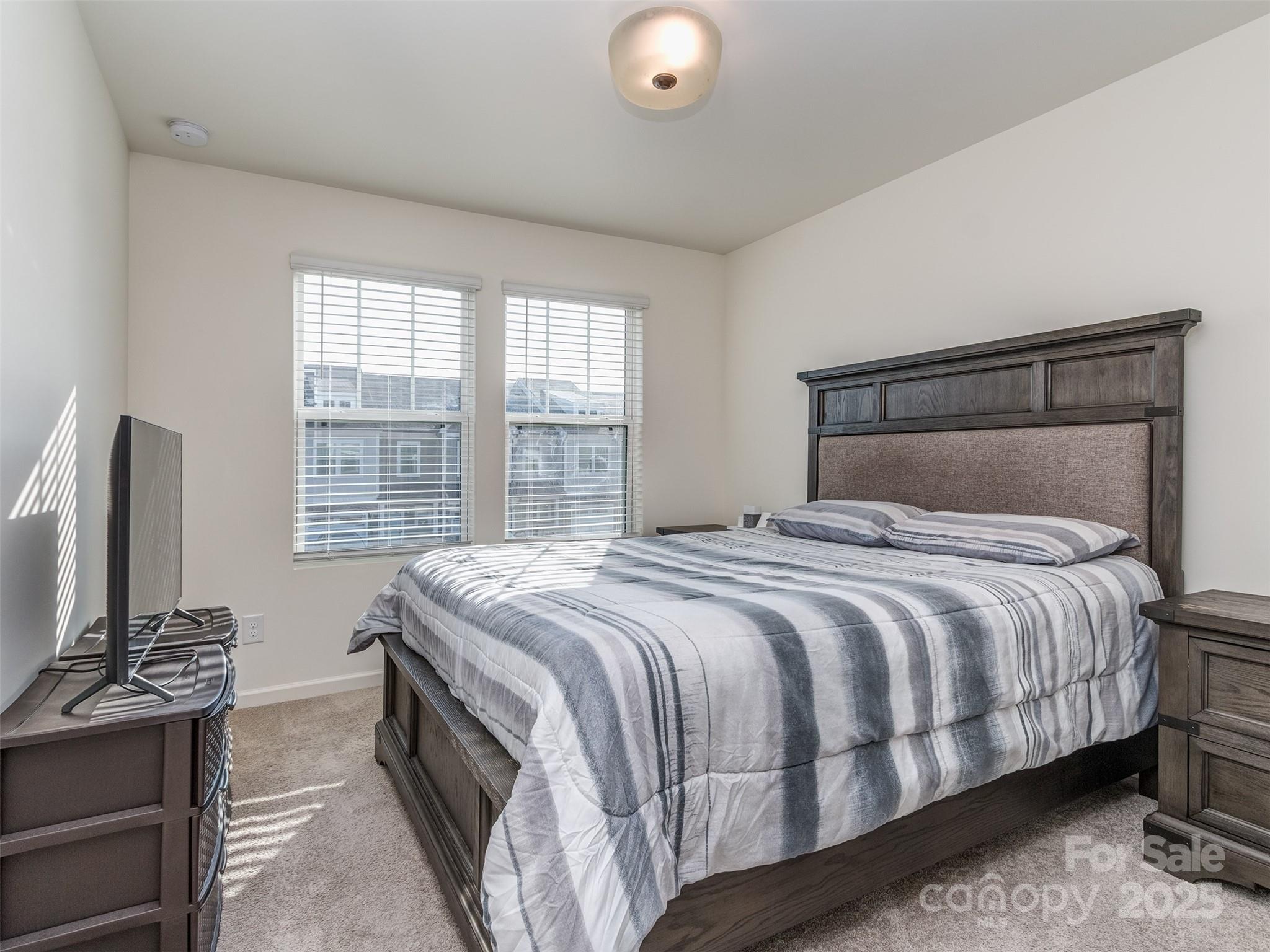 2024 Crooked Oak Lane York, SC 29745 - Photo 20 of 25 a bedroom with a bed and a flat screen tv