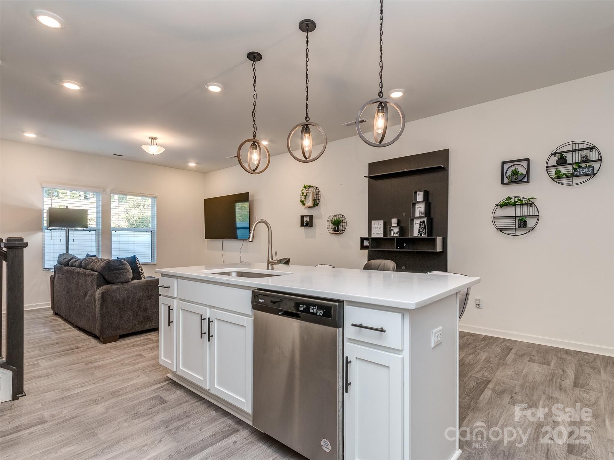 2024 Crooked Oak Lane York, SC 29745 - Photo 10 of 25 a kitchen with a sink and dishwasher with wooden floor