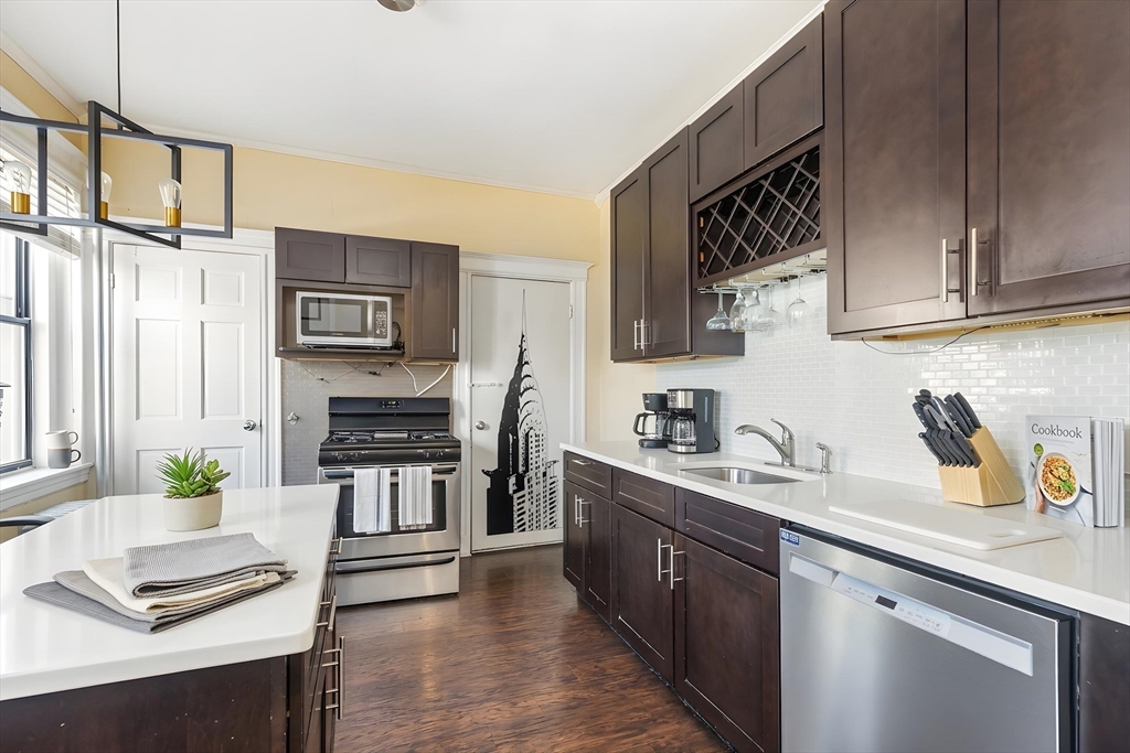 21 Royal Street, Unit 1 Boston, MA 02134 - Photo 1 of 17 a kitchen with stainless steel appliances a stove sink and cabinets