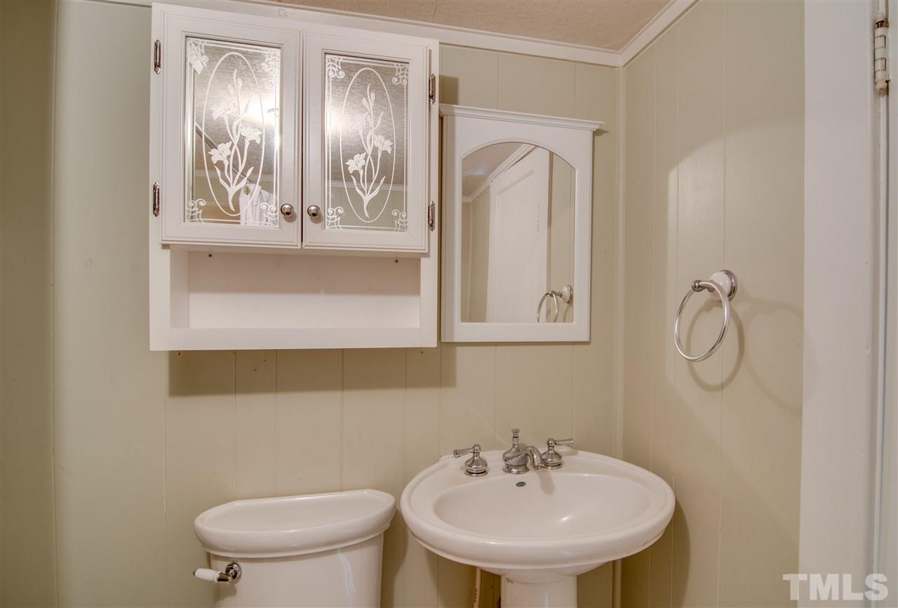 7121 Blalock Road Bahama, NC 27503 - Photo 8 of 17 a bathroom with a toilet sink and mirror