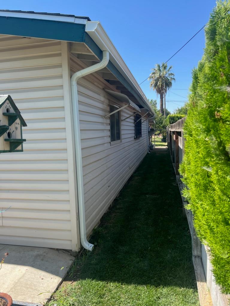 229 E Street Los Banos, CA 93635 - Photo 2 of 9 a backyard of a house with plants and entertaining space