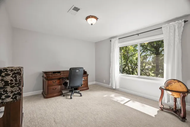 a bedroom with a bed dresser and a window