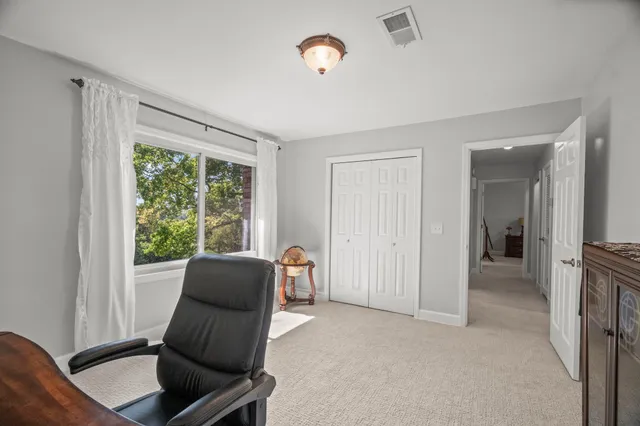 a bedroom with a bed dresser and a window