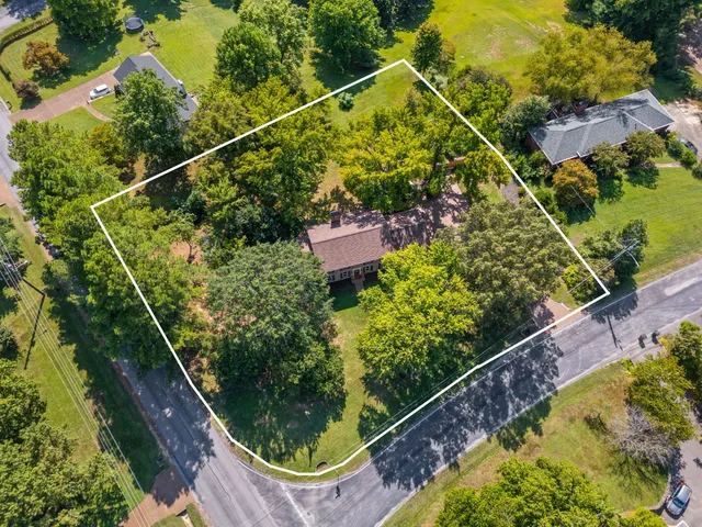 a view of an entryway with dining area windows wooden floor and livingroom