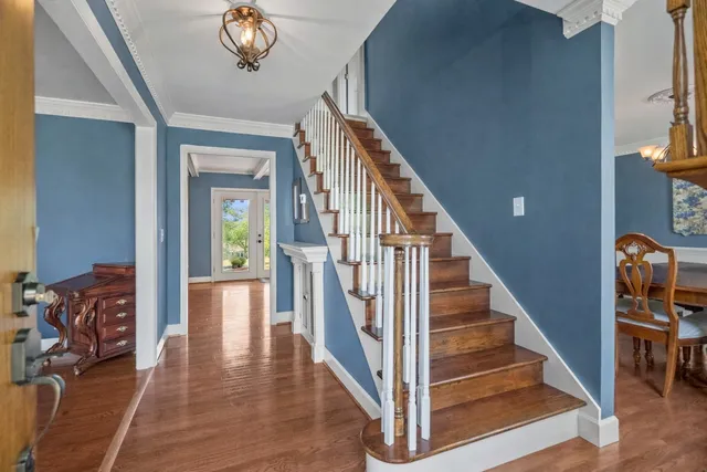 a view of a dining room with furniture and chandelier
