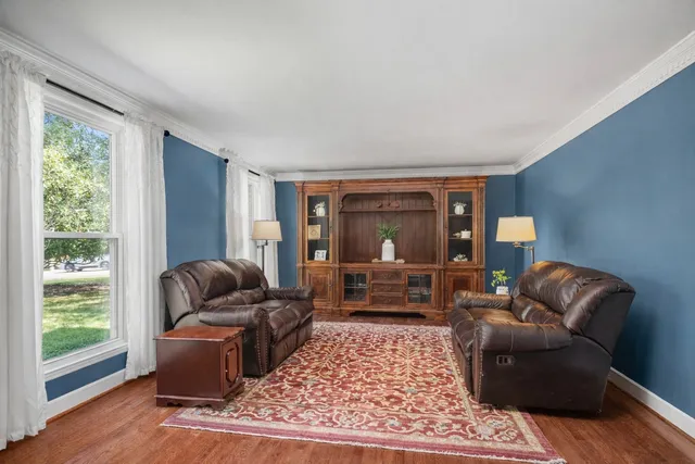 a living room with furniture and a chandelier