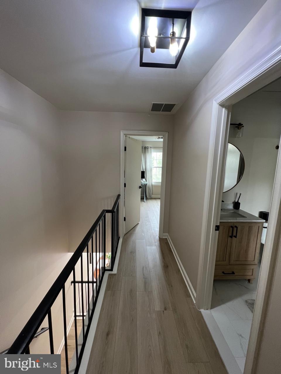 20202 Foothill Terrace Ashburn, VA 20147 - Photo 13 of 26 a view of a hallway with wooden floor and staircase