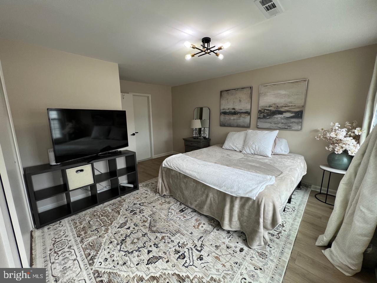 20202 Foothill Terrace Ashburn, VA 20147 - Photo 16 of 26 a bedroom with a bed and a flat screen tv