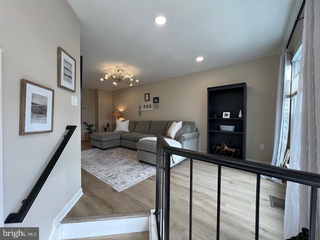 20202 Foothill Terrace Ashburn, VA 20147 - Photo 2 of 26 a living room with furniture and a chandelier