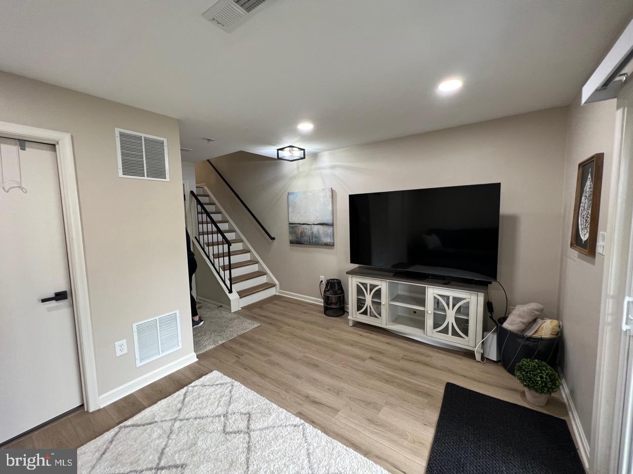 20202 Foothill Terrace Ashburn, VA 20147 - Photo 23 of 26 a living room with furniture and a flat screen tv