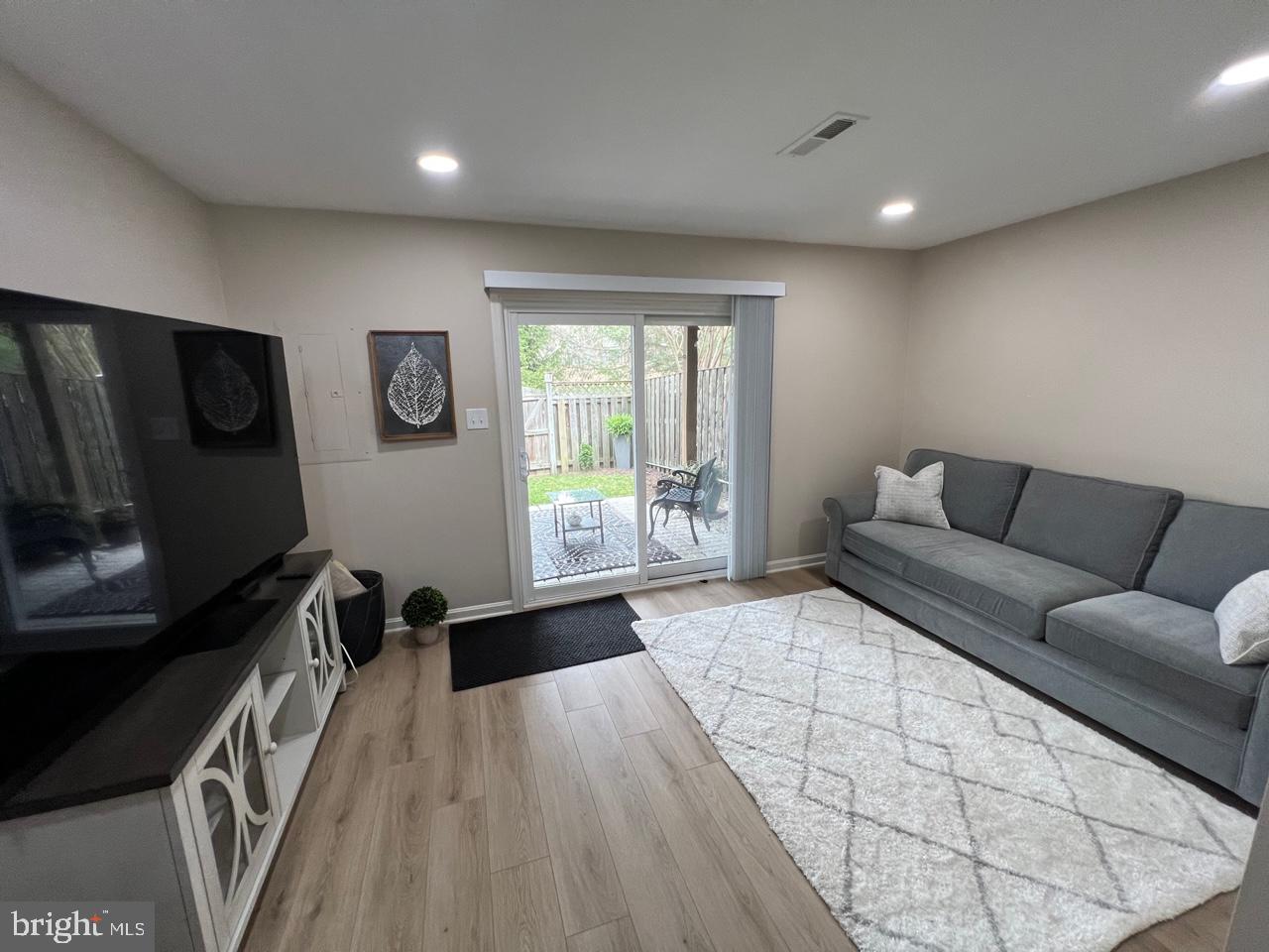 20202 Foothill Terrace Ashburn, VA 20147 - Photo 24 of 26 a living room with furniture and a flat screen tv