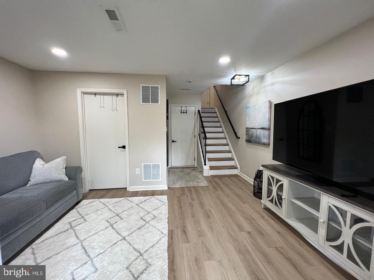 20202 Foothill Terrace Ashburn, VA 20147 - Photo 25 of 26 a living room with furniture and a flat screen tv