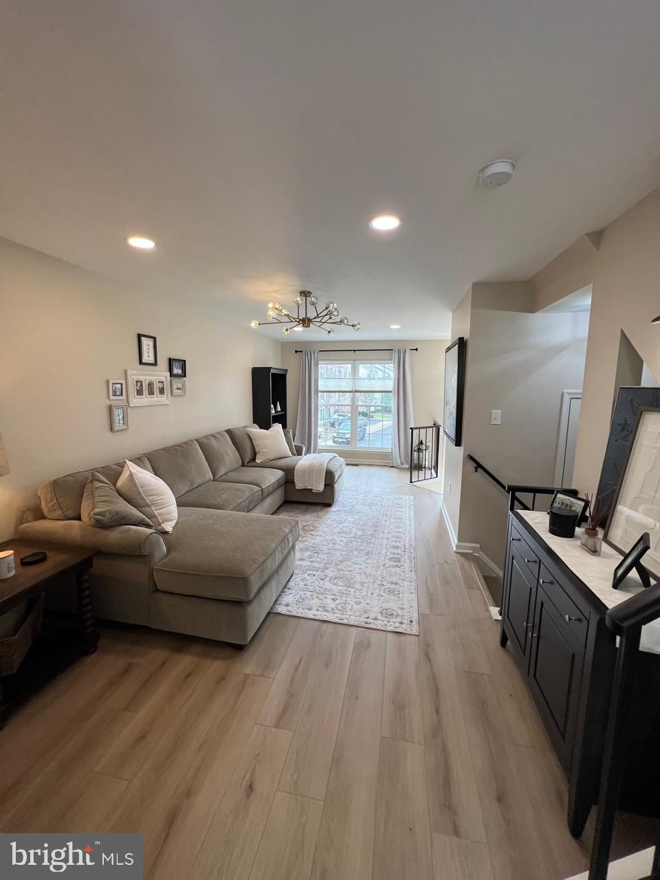 20202 Foothill Terrace Ashburn, VA 20147 - Photo 6 of 26 a living room with furniture and a flat screen tv