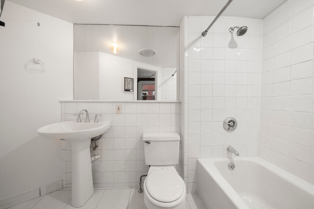 7 Unity Street, Unit 3 Boston, MA 02113 - Photo 21 of 25 a bathroom with a sink a toilet and shower