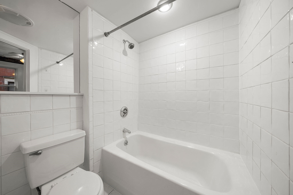 7 Unity Street, Unit 3 Boston, MA 02113 - Photo 22 of 25 a white toilet and tub sitting next to a bathroom sink