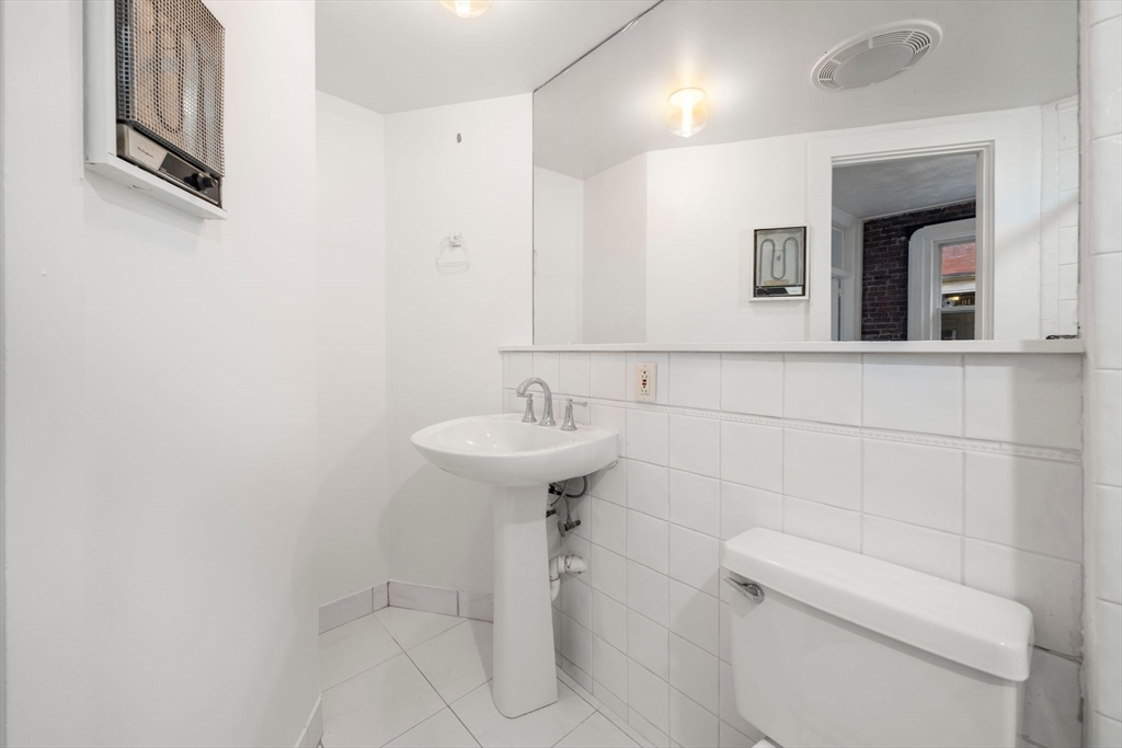 7 Unity Street, Unit 3 Boston, MA 02113 - Photo 23 of 25 a bathroom with a sink a toilet and mirror