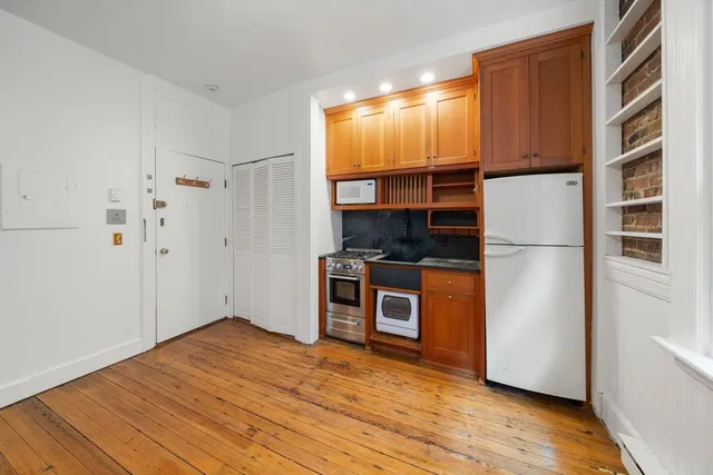 a kitchen with stainless steel appliances a refrigerator and a stove top oven