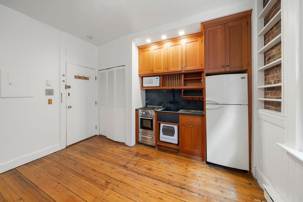 7 Unity Street, Unit 3 Boston, MA 02113 - Photo 5 of 25 a kitchen with stainless steel appliances a refrigerator and a stove top oven