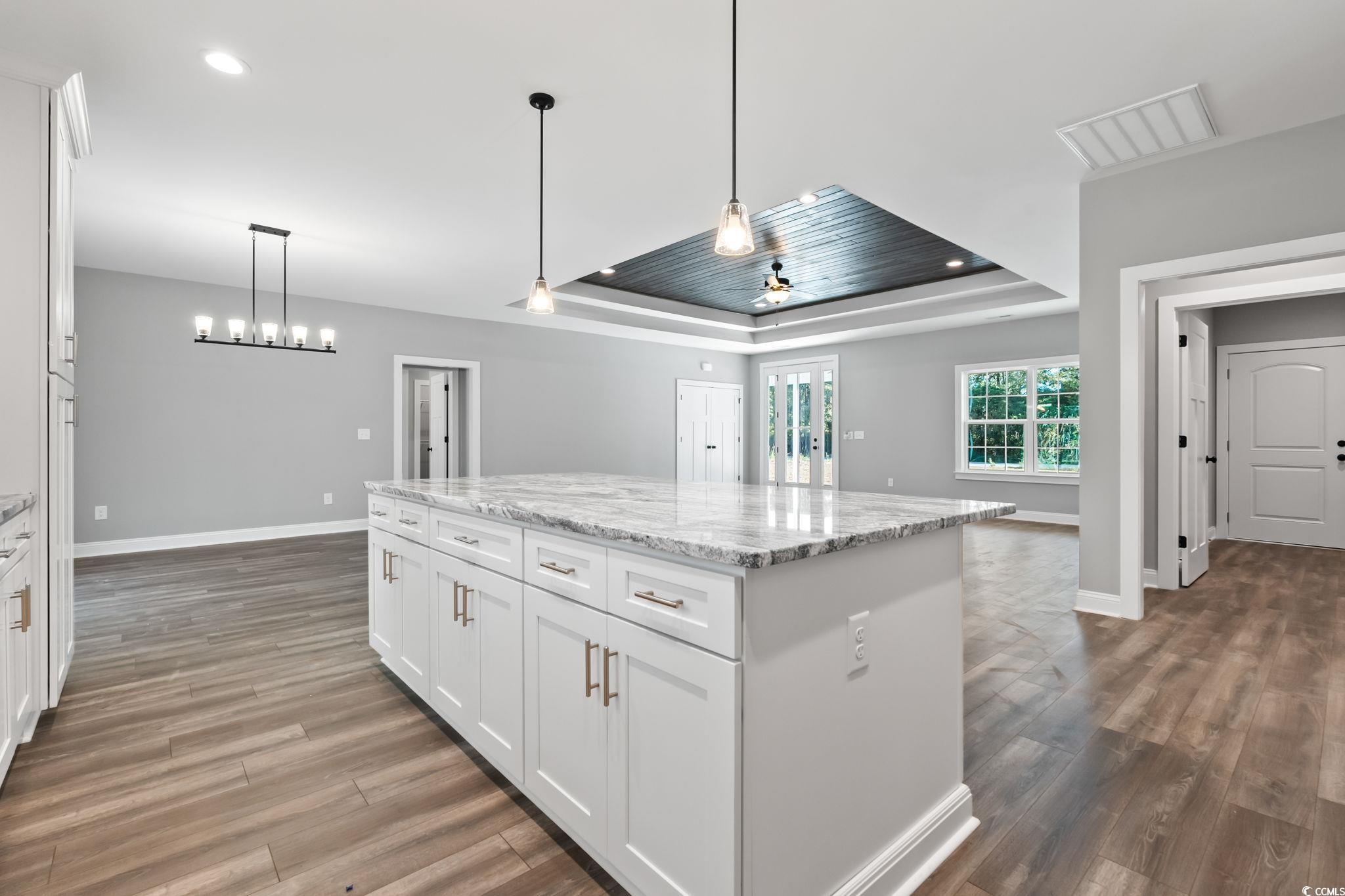 2122 Highway 9 Business Loris, SC 29569 - Photo 12 of 32 Kitchen featuring white cabinets, hanging light fixtures, light stone counters, a center island, and recessed lighting